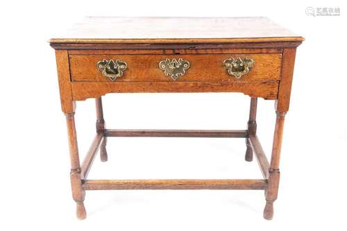 An early 18th-century oak single drawer lowboy, with thumb, ...