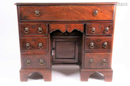 A George III mahogany kneehole dressing chest, the frieze dr...