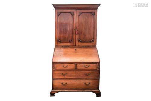 A George III mahogany bureau bookcase. The upper section wit...