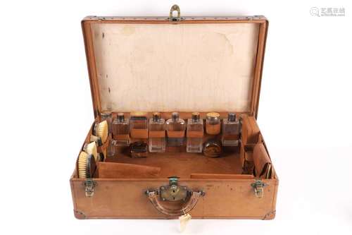 A fine early 20th-century tan leather travelling case by Lou...