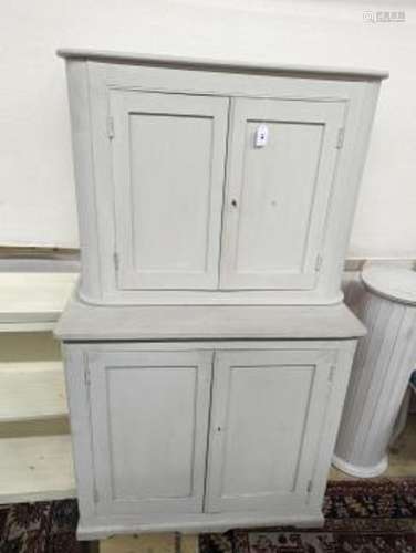 A white painted two section kitchen cupboard of small propor...