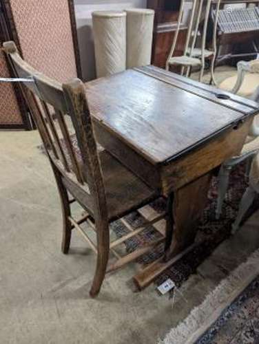 A vintage oak student's desk, width 57cm, depth 46cm, height...