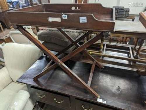 A 19th century rectangular mahogany butler's tray on folding...