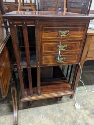 An Edwardian inlaid rosewood revolving bookcase fitted three...