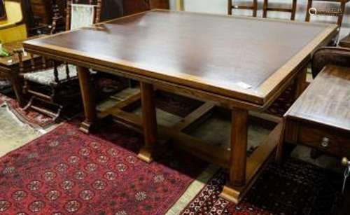 A large rectangular oak dining or boardroom table on six col...