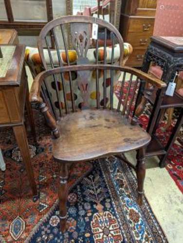 A mid 19th century Windsor yew and elm Windsor elbow chair, ...