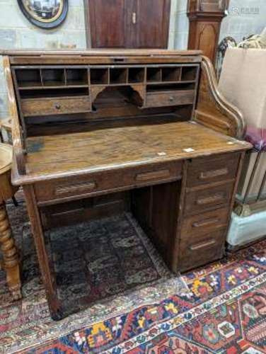 An early 20th century oak roll top desk with 'S' shaped tamb...