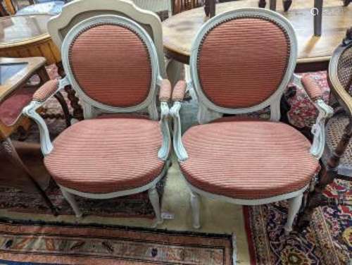 A pair of early 20th century French painted upholstered armc...