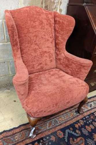 A Queen Anne style upholstered wingback armchair, width 78cm...