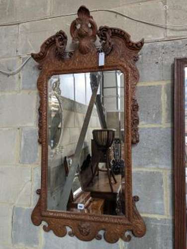 An 18th century style carved wood wall mirror, width 64cm, h...