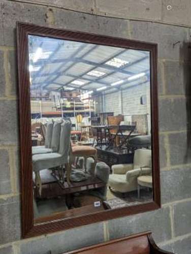 An oak framed rectangular wall mirror with fluted border, wi...