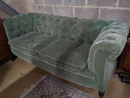 A late Victorian Chesterfield settee upholstered in buttoned...