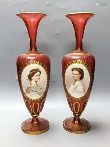 A pair of Bohemian enamelled and overlaid cranberry glass va...