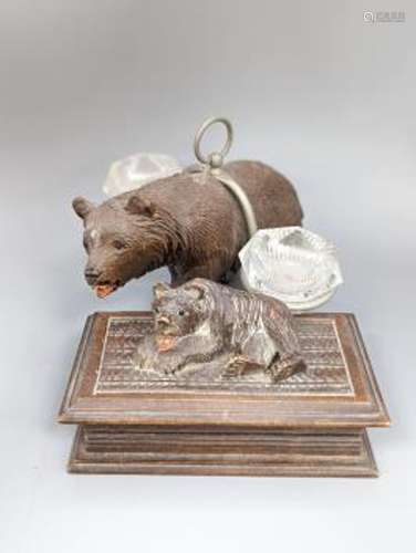 A Black forest carved bear cruet, width 13cm, and a similar ...