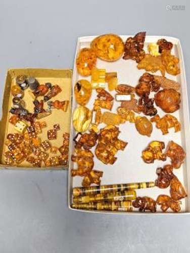 A mixed collection small carved amber wares including dice, ...