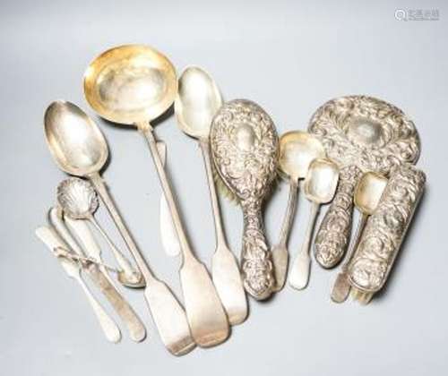 A group of silver flatware including a Victorian soup ladle ...