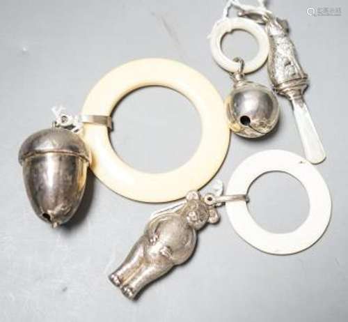 Four assorted child's silver teething rattles, including dog...