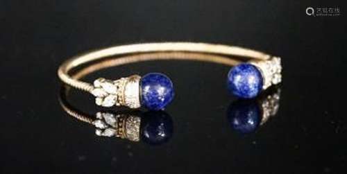 A modern yellow metal twist, two stone sodalite? and diamond...