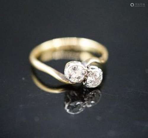 An 18ct & plat, two stone diamond crossover ring, size J, gr...