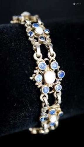 A continental gilt white metal, sapphire and split pearl flo...