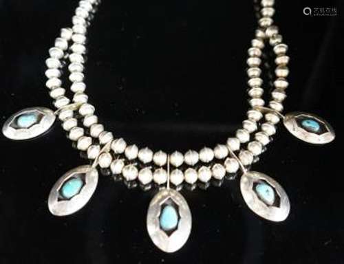 A 20th century South American? white metal and turquoise set...