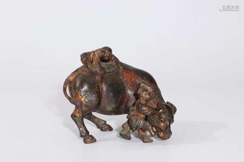 A BRONZE EFFIGY OF BUFFALO AND BOY