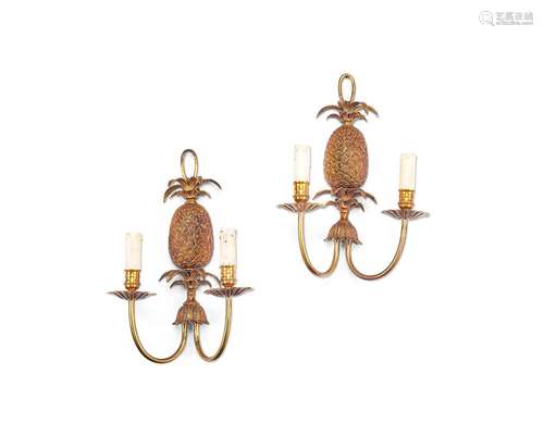 A pair of gilt brass twin-light pineapple wall lights