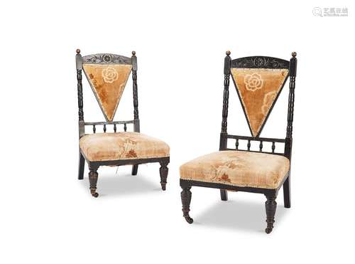 A pair of late Victorian Aesthetic period ebonised salon cha...