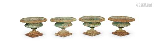 A set of four late 19th century green painted cast iron urns