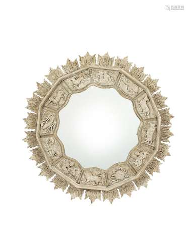 A grey painted mirror carved with the astrological signs of ...