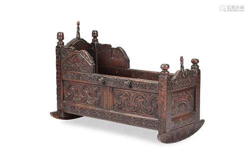 A Charles II carved oak cradle, initialled 'M H M'...