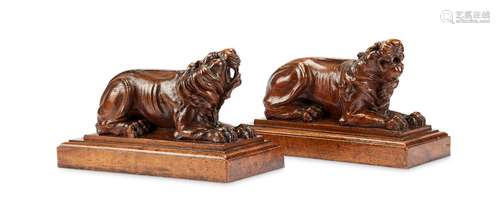 A pair of carved walnut recumbent lions, mid 19th century