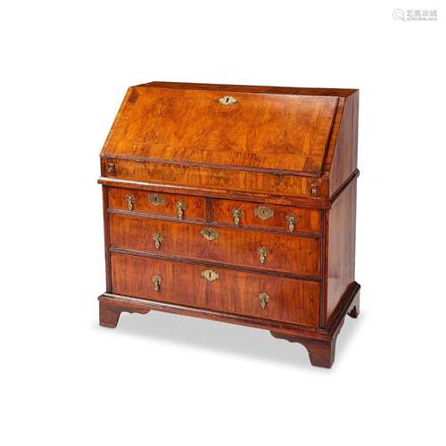 A George I figured walnut and featherbanded bureau