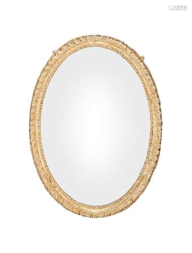 A George III oval giltwood carved frame with later mirror pl...