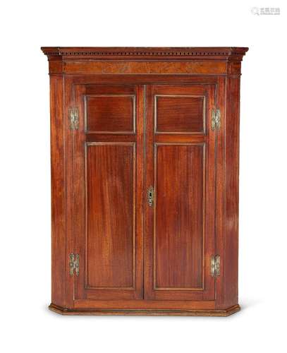 A George III mahogany corner cupboard