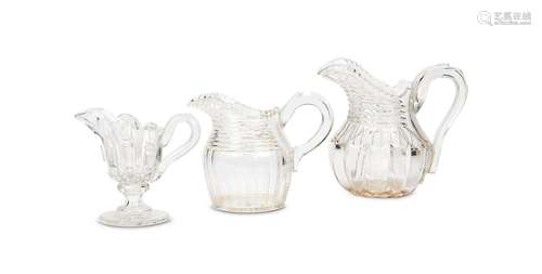 Three early 19th century English cut glass water jugs