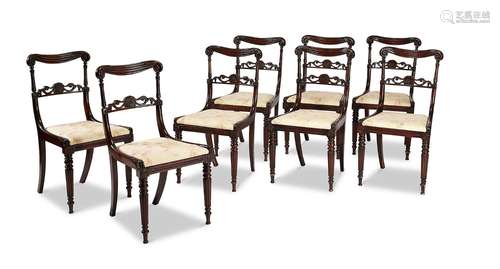 A set of eight Regency rosewood carved dining chairs