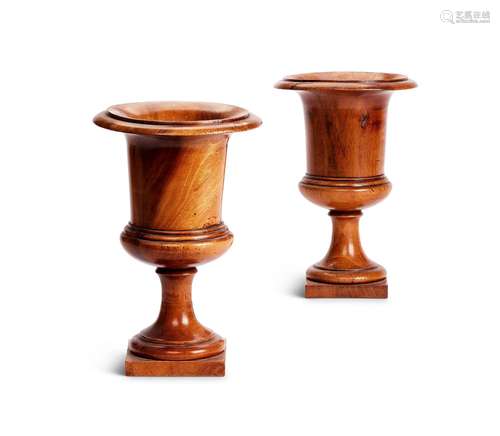 A pair of Regency turned walnut Medici vases