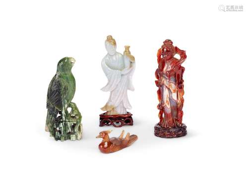 A celadon jade figure of a deity and three other figures