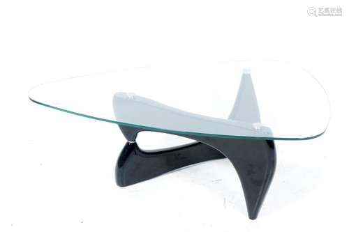 Design coffee table with black high-gloss base and glass top...