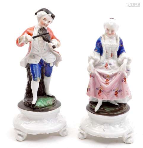 2 Polychrome porcelain figurines of a man playing the violin...