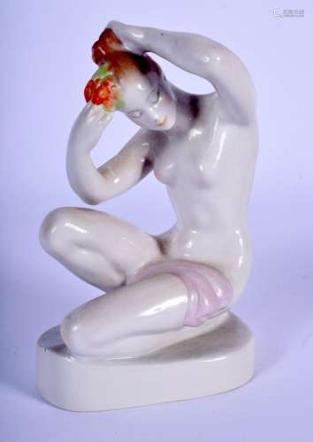 A HUNGARIAN PORCELAIN FIGURE OF A NUDE FEMALE modelled placi...