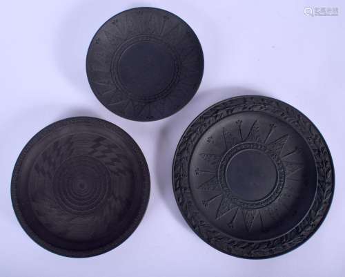 TWO 19TH CENTURY BLACK BASALT CIRCULAR PLATES one decorated ...