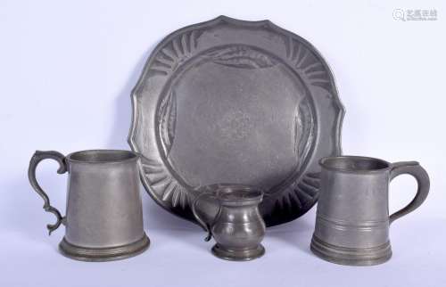 AN ANTIQUE PEWTER JUG together with two others and an trivet...