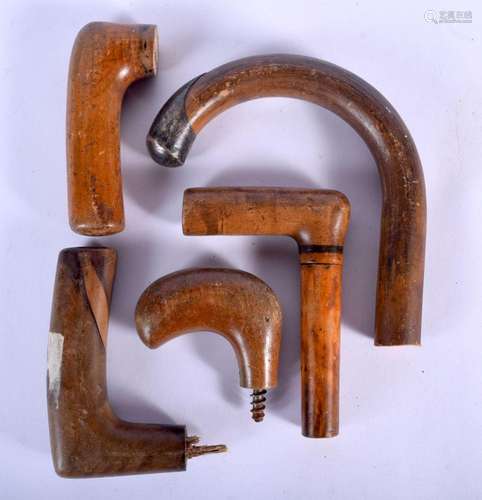 FIVE VINTAGE WOOD WALKING CANE HANDLES. Largest 10 cm x 7 cm...