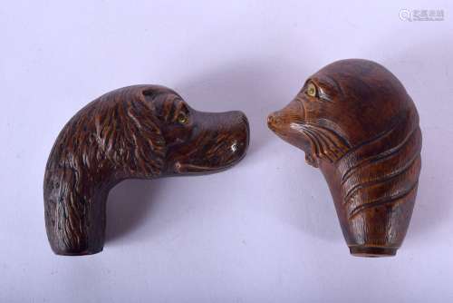 TWO BLACK FOREST STYLE CANE HANDLES one formed as a seal, th...