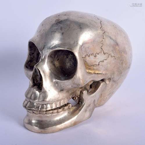 A SILVER PLATED SKULL. 14 cm x 11 cm.