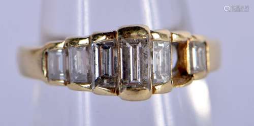 AN 18CT GOLD AND DIAMOND BAGUETTE CUT RING. 5.6 grams. M.