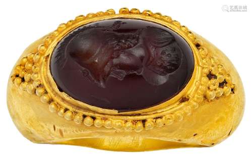 A carnelian intaglio ring, in the Roman style, set with an o...