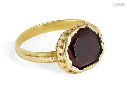 A garnet ring, centring on a mixed-cut octagonal garnet, ins...